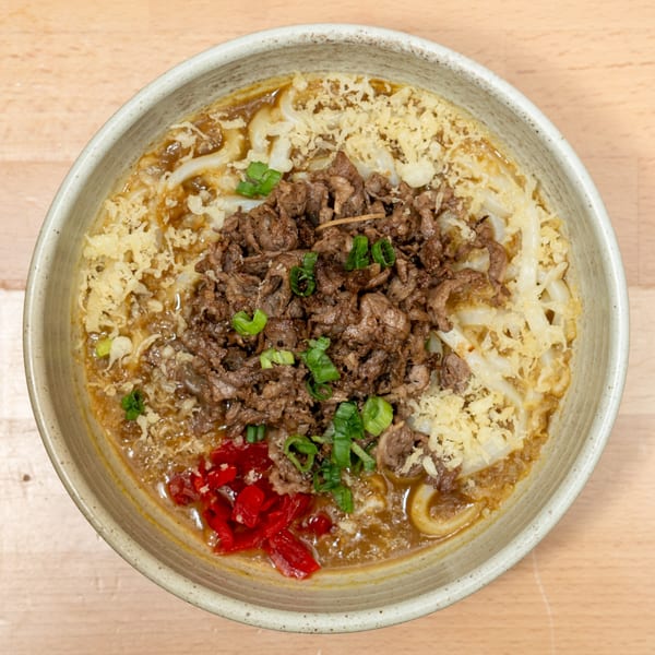 Curry Do's Japanese curry udon with beef, tempura flakes, red ginger, and green onions.
