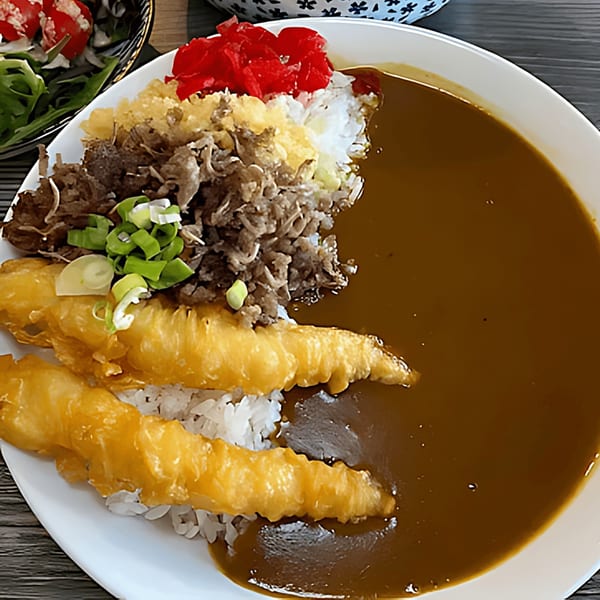 Japanese curry with rice, beef, tempura shrimp, pickled ginger, and green onions.