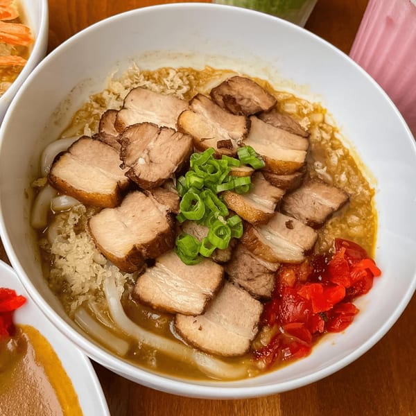 Curry Do's Japanese curry udon with sliced pork belly, green onions, and pickled ginger.