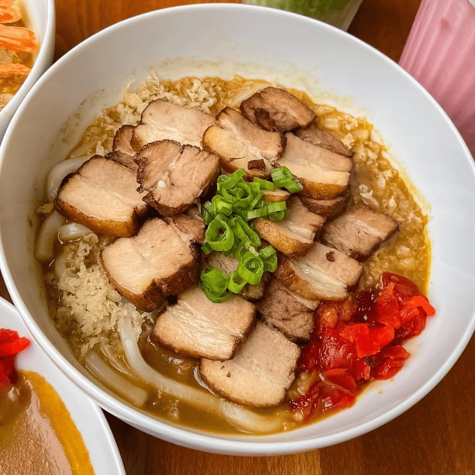 Curry Do's Japanese curry udon with sliced pork belly, green onions, and pickled ginger.